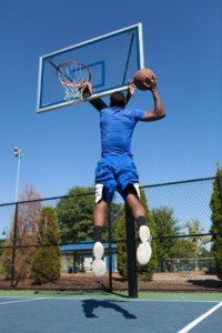 man dunking on outdoor in-ground hoop