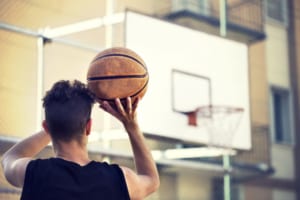 A man preparing to shoot a basketball at a hoop